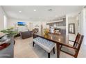 Open concept dining room with large table and living room view at 12530 W Levi Dr, Avondale, AZ 85323