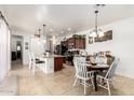 Bright and airy kitchen featuring a breakfast bar, dining area and stainless steel appliances at 14765 W Alexandria Way, Surprise, AZ 85379