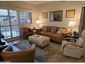 Spacious living room featuring leather couches and a large window at 14950 W Mountain View Blvd # 5112, Surprise, AZ 85374