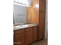 Bathroom featuring a vanity with built-in storage and a large mirror at 1825 W Ray Rd # 2031, Chandler, AZ 85224