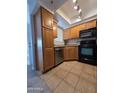 Bright kitchen featuring wood cabinetry and stainless steel dishwasher at 1825 W Ray Rd # 2031, Chandler, AZ 85224