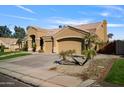 Exterior elevation of the home featuring an attached two-car garage and desert landscaping at 1890 W Wisteria Dr, Chandler, AZ 85248