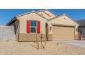 Newly built home with red shutters and a two-car garage at 23256 W Miami St, Buckeye, AZ 85326