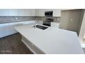 Modern kitchen with white cabinets and large island at 23285 W Florence Ave, Buckeye, AZ 85326