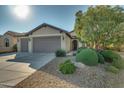 Well-maintained home with two-car garage and mature trees at 26335 W Burnett Rd, Buckeye, AZ 85396