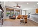 Spacious living room features a large sectional sofa and lots of natural light at 26335 W Burnett Rd, Buckeye, AZ 85396