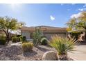 Single-story home with desert landscaping and two-car garage at 2927 W Plum Hollow Dr, Anthem, AZ 85086