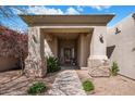 Inviting front entrance with stone accents, shade trees, and a landscaped walkway at 300 N Portland Ave, Gilbert, AZ 85234