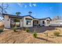 A sprawling backyard showcases the home's elegant exterior and ample space for outdoor activities at 3021 N 47Th St, Phoenix, AZ 85018