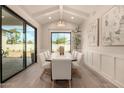 Elegant dining room featuring a modern chandelier, large windows, and stylish decor at 3021 N 47Th St, Phoenix, AZ 85018