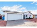 Front view of a single-story home with a two-car garage at 3837 W Port Au Prince Ln, Phoenix, AZ 85053