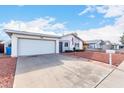 House exterior featuring a two-car garage and manicured lawn at 3837 W Port Au Prince Ln, Phoenix, AZ 85053