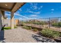 Covered patio overlooks a fenced backyard with desert landscaping at 4483 N 203Rd Ave, Buckeye, AZ 85396