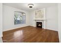 Bright living room with hardwood floors and a marble fireplace at 6025 E Palomino Ln, Scottsdale, AZ 85266