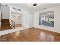 Open living room with hardwood floors and a staircase at 6025 E Palomino Ln, Scottsdale, AZ 85266