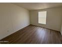 Simple bedroom with wood-look flooring and a window with blinds at 8832 E Pueblo Ave # 29, Mesa, AZ 85208