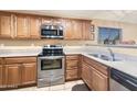 Kitchen features stainless steel appliances and light wood cabinets at 11422 W Pinehollow Dr, Surprise, AZ 85378