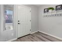 Front entry with white door, gray flooring and coat rack at 11830 W Avenida Del Sol --, Sun City, AZ 85373