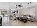 Spacious living room with neutral color palette and a view into the kitchen at 1195 E Dust Devil Dr, San Tan Valley, AZ 85143