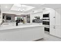 Modern kitchen featuring white cabinets, stainless steel appliances, and a large island at 12210 N 76Th Pl, Scottsdale, AZ 85260