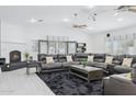 Relaxing living room with a large sectional sofa and a fireplace at 12210 N 76Th Pl, Scottsdale, AZ 85260