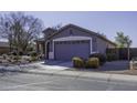 Front view of a one-story house with a gray exterior and landscaping at 1229 E Prickly Pear St, Casa Grande, AZ 85122