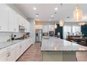 Bright kitchen showcasing a large center island, ample counter space, and modern appliances at 12349 N 145Th Ave, Surprise, AZ 85379