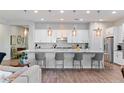 Stylish kitchen with a large island, pendant lighting, and seating at 12349 N 145Th Ave, Surprise, AZ 85379