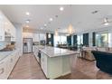 Open-concept kitchen featuring a large center island and stainless steel appliances at 12349 N 145Th Ave, Surprise, AZ 85379