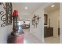 Bright hallway with decorative wall art and a wooden cabinet at 1238 W Silver Creek Ln, San Tan Valley, AZ 85140