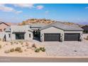 Stunning desert contemporary home with a three-car garage and landscaped front yard at 13238 E Ranch Gate Rd, Scottsdale, AZ 85255