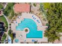 Aerial view of a community pool with lounge chairs and mature landscaping at 1351 N Pleasant Dr # 2172, Chandler, AZ 85225