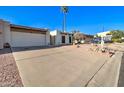 Front view of a tan house with a two-car garage and a gravel driveway at 14228 N Yerba Buena Way, Fountain Hills, AZ 85268