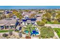 Aerial view showcasing a house with a pool, solar panels and lush backyard at 14905 W Dovestar Dr, Surprise, AZ 85374