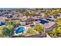 Aerial view of a house with solar panels and a pool in a residential neighborhood at 14905 W Dovestar Dr, Surprise, AZ 85374