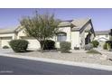 Tan house with a two-car garage, landscaping, and a walkway at 1548 E Melrose Dr, Casa Grande, AZ 85122