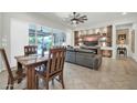 Dining area with wooden table and chairs, near living room at 18961 N 264Th Ave, Buckeye, AZ 85396