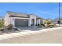 Single-story home with gray garage door, landscaping, and mountain views at 18961 N 264Th Ave, Buckeye, AZ 85396