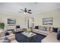 Bright living room with a ceiling fan, plush seating, stylish decor, and a beautiful blue rug at 1934 E Brill St, Phoenix, AZ 85006