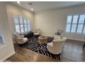 Bright sitting room features plantation shutters, hardwood floors, and stylish seating arrangement with a zebra-patterned rug at 20490 N 78Th Way, Scottsdale, AZ 85255