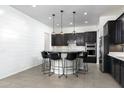 Modern kitchen featuring dark wood cabinets and granite countertops at 21004 E Sunset Dr, Queen Creek, AZ 85142