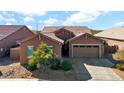 One-story home with a two-car garage and desert landscaping at 23776 N 167Th Ln, Surprise, AZ 85387