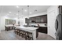 Modern kitchen with dark cabinetry, island, and stainless steel appliances at 23776 N 167Th Ln, Surprise, AZ 85387