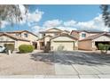 Two-story house with a beige exterior, two-car garage, and landscaped front yard at 28125 N Silver Ln, San Tan Valley, AZ 85143