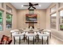 Contemporary dining room with modern lighting, decorative stone accent wall, and ample seating for Gathering and guests at 28247 N 128Th Dr, Peoria, AZ 85383