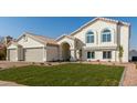 Two-story home with a three-car garage and well-manicured lawn at 3258 E Dover St, Mesa, AZ 85213