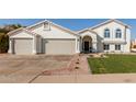 Two-story home with a three-car garage and well-manicured lawn at 3258 E Dover St, Mesa, AZ 85213