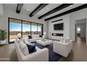 Bright living room with sliding glass doors leading to the backyard and a fireplace at 34045 N Borgata Trl, Queen Creek, AZ 85144