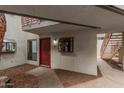 Condo red front door with window accent and exterior corridor at 3405 W Danbury Dr # D121, Phoenix, AZ 85053