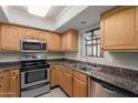 Well-lit kitchen with stainless steel appliances and granite countertops at 3405 W Danbury Dr # D121, Phoenix, AZ 85053